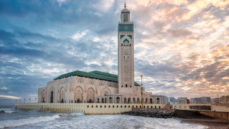 Casablanca travel guide Hassan II Mosque at sunset by the Atlantic Ocean