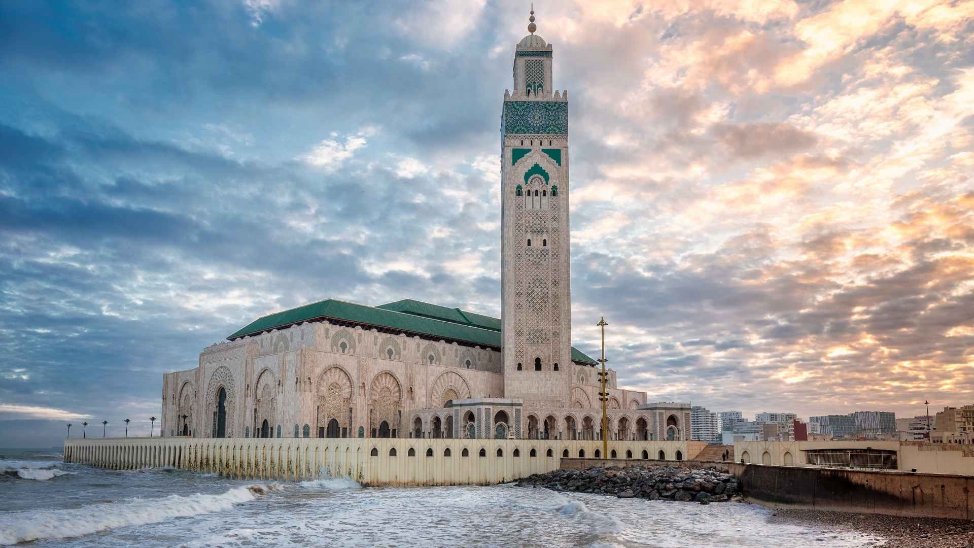 Casablanca travel guide Hassan II Mosque at sunset by the Atlantic Ocean