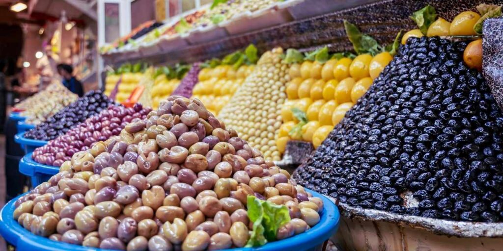 Traditional olive stalls in Meknes medina market with green and black olives on display