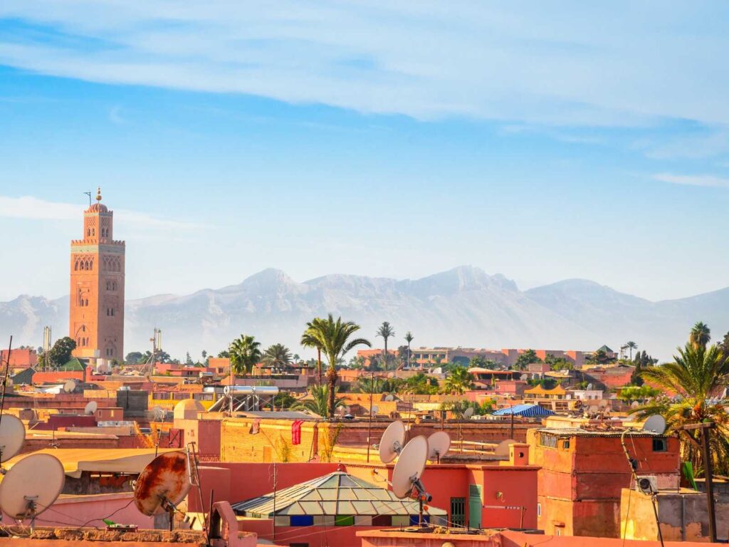 Rooftops of Marrakech with the Koutoubia Mosque and Atlas Mountains in the background
