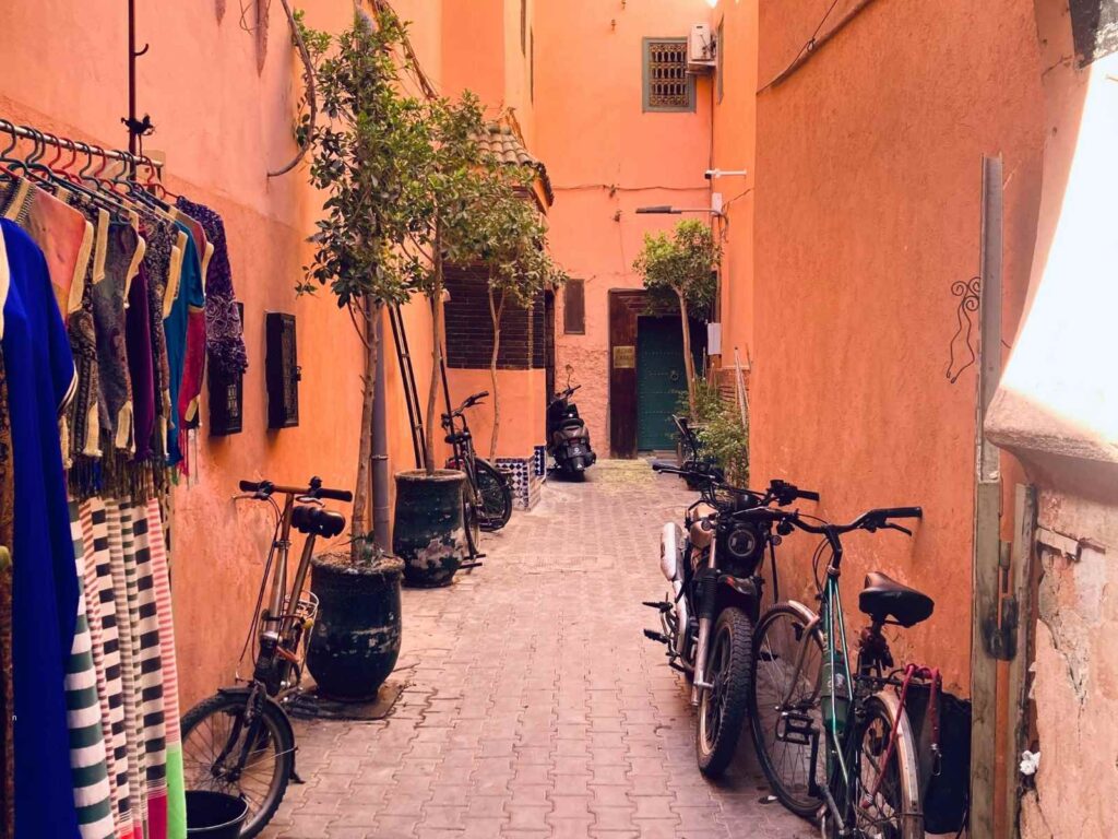 Narrow residential alley in a Moroccan medina with bicycles and hanging clothes