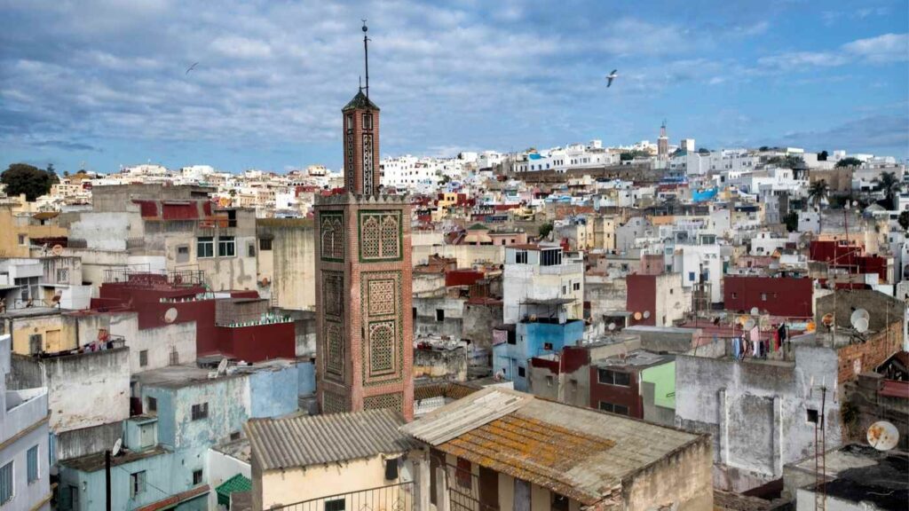 Panoramic view of the old medina of Fes with traditional houses and a mosque minaret