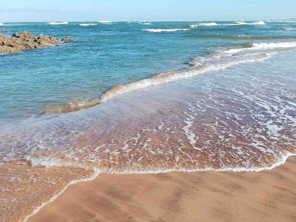 Moroccan coastline with gentle waves and sandy beach