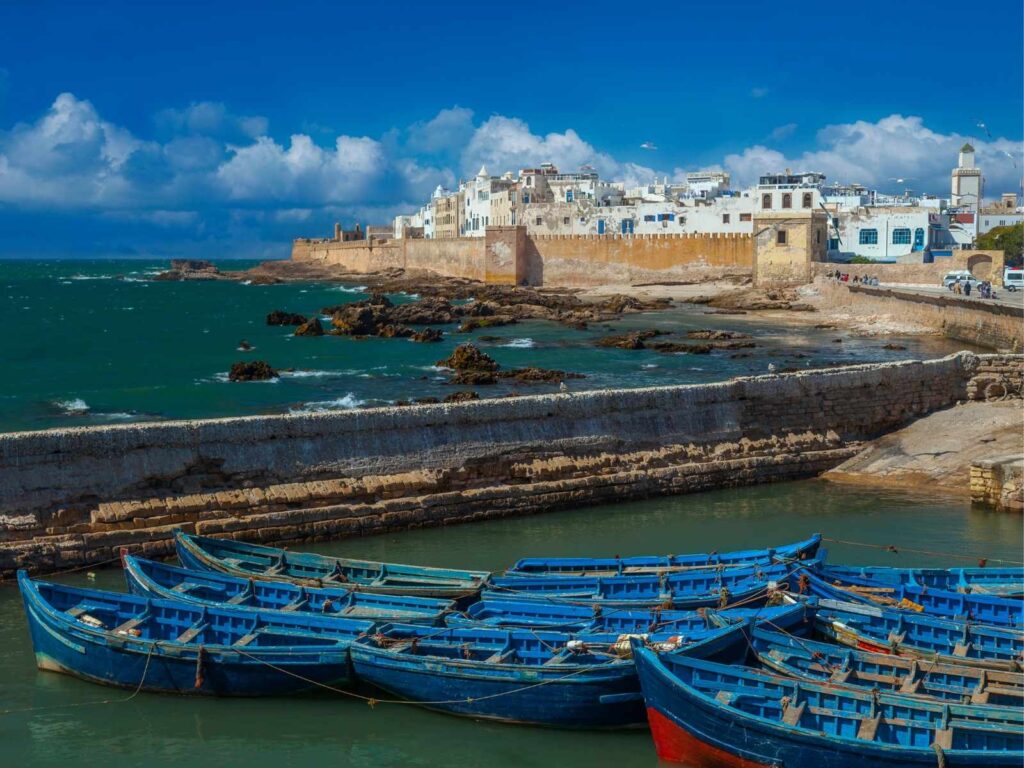 Essaouira fishing port with blue boats and historic medina walls