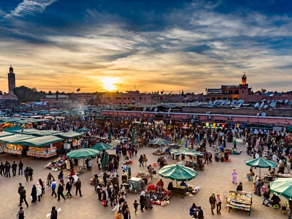 Jemaa el-Fna square at sunset with food stalls and crowds