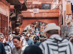 Crowded medina street in Marrakech with souks, cafés, and daily life