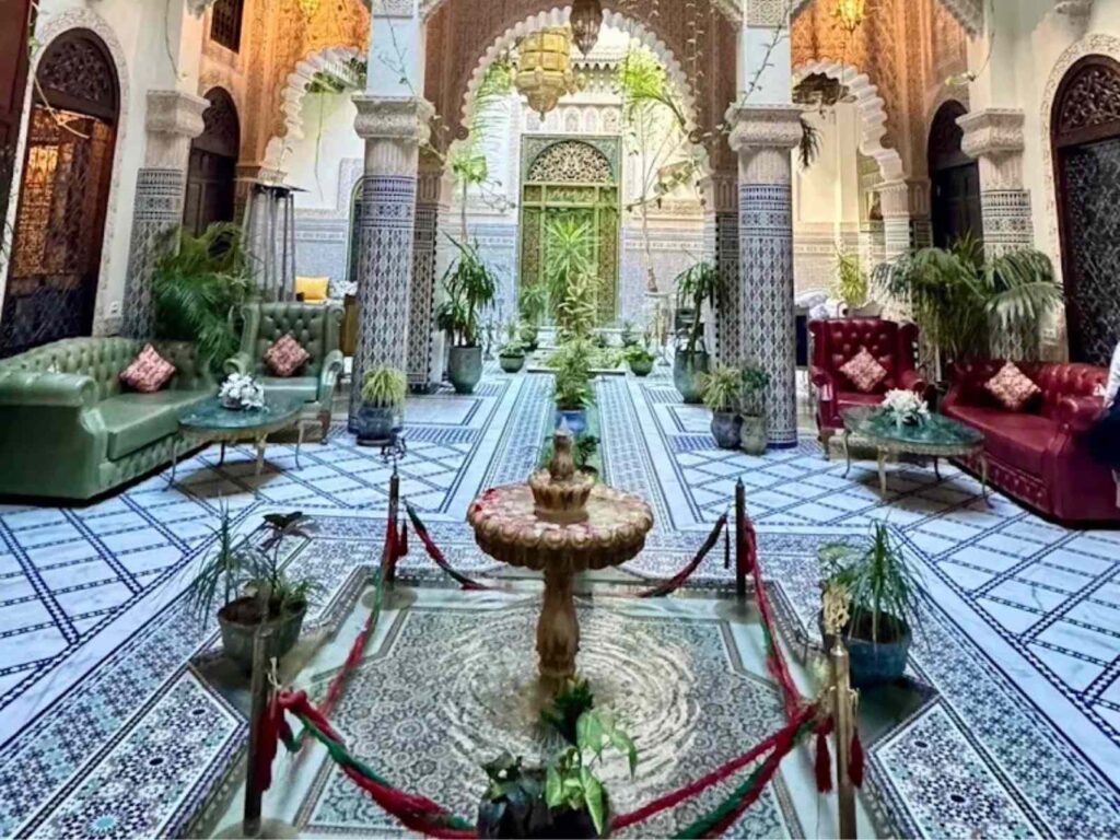 Fes travel guide, Traditional riad courtyard in Fes medina with Moroccan tilework and fountain