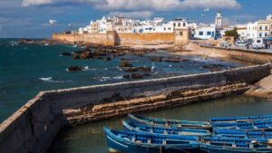 Essaouira Morocco ramparts overlooking the Atlantic Ocean with blue fishing boats