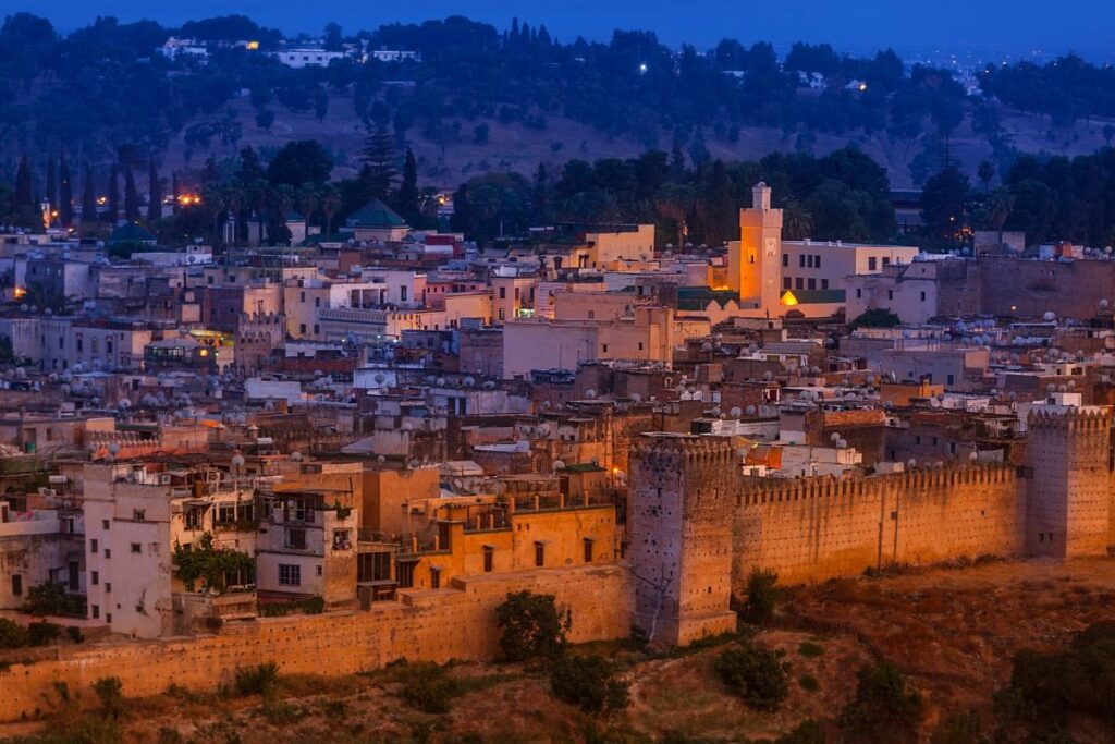 Fes medina at dusk with illuminated historic walls